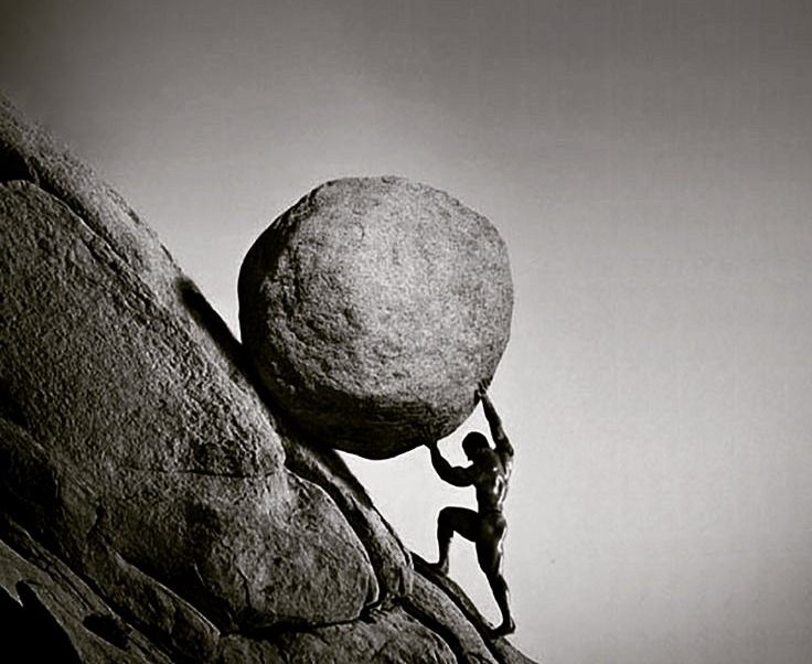 A lone man rolling a heavy boulder upwards towards top of mountain indicating the rise and strength.